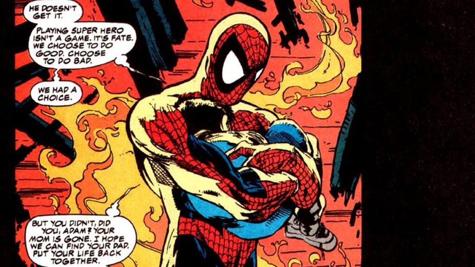 Spider-Man holds child in a fire