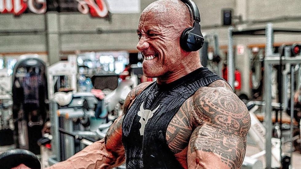 The Rock doing curls at the gym