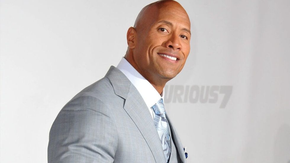 The Rock in a light grey suit at a Fast Furious premiere