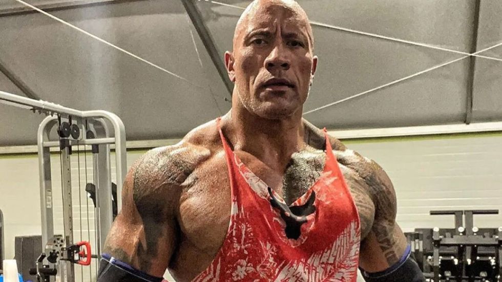The Rock looking swole at the gtm in a red shirt