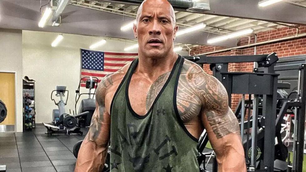 The rock looking very muscular at the gym