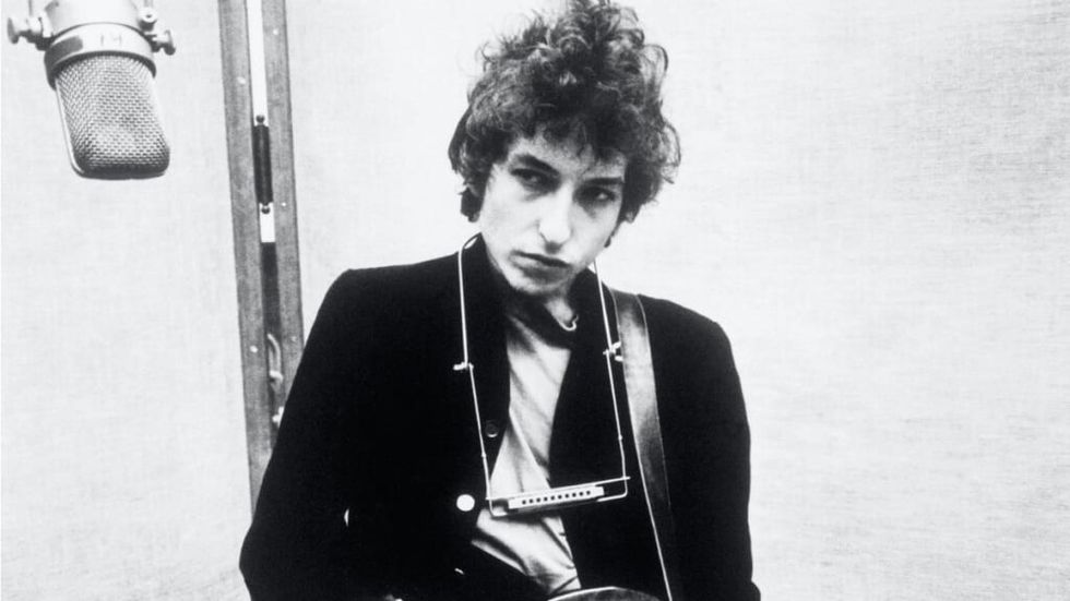 Bob Dylan Alb-negru în fața unui microfon într-un studio