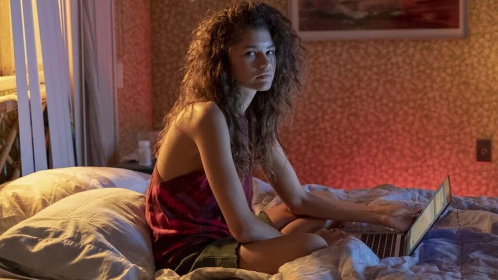 Zendaya's Rue in Ruphoria looking depressed on a bed with her laptop