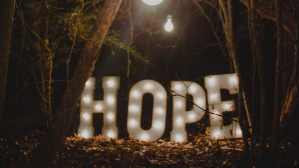 the word "hope" in a forest gathering