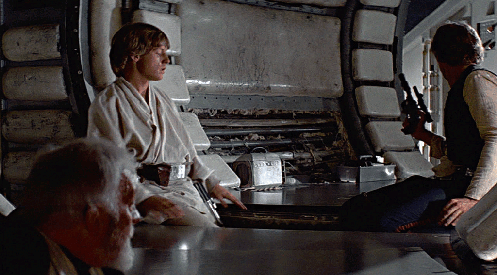 Alec Guinness as Obi-Wan Kenobi, Mark Hamill as Luke Skywalker and Harrison Ford as Han Solo, in Star Wars: A New Hope (1977)