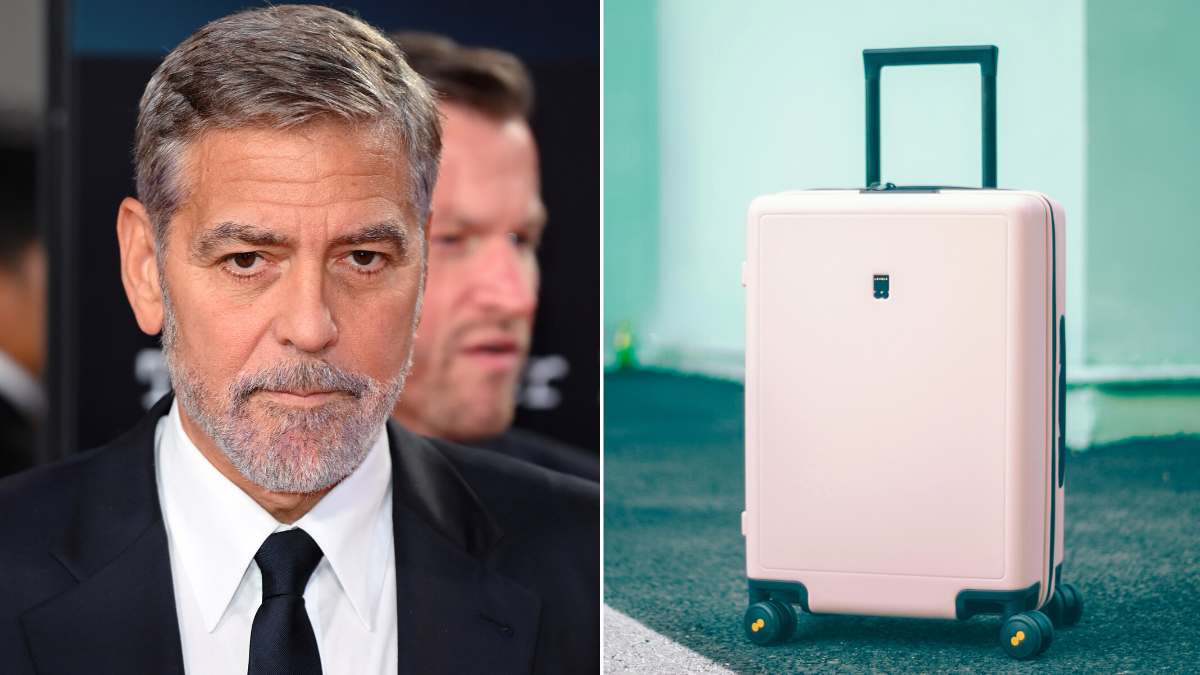 man in a black suit and a pink suitcase