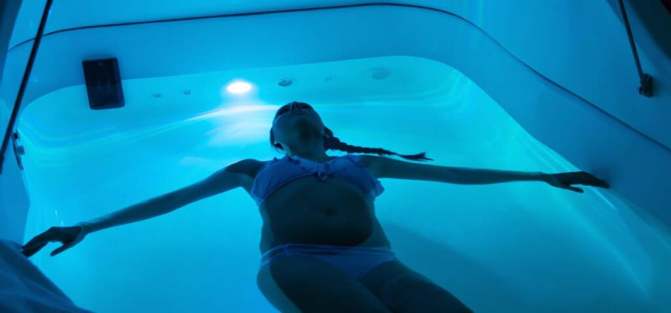 Young woman in sensory deprivation tank