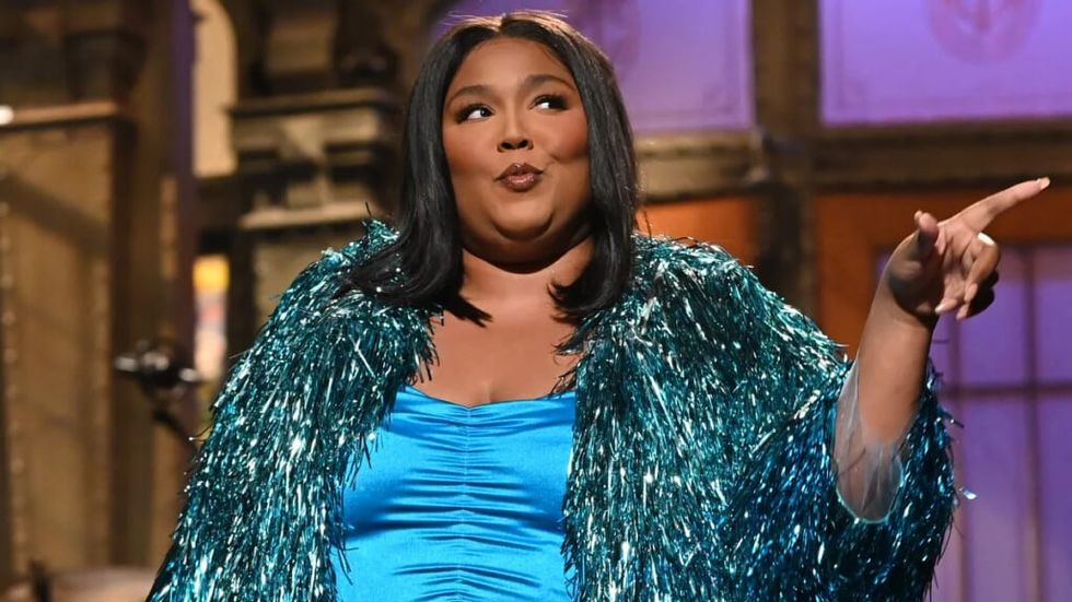 Lizzo hosting SNL in a blue dress and frock