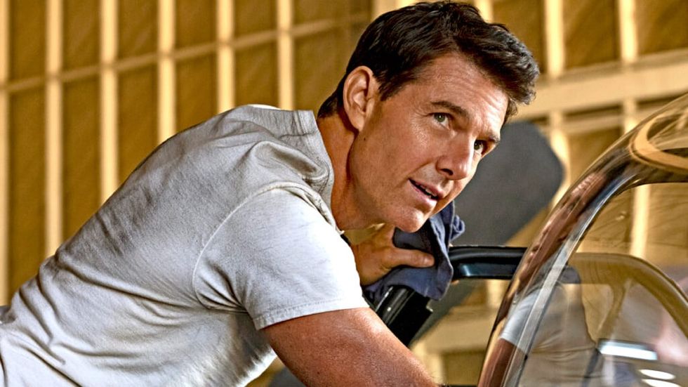 Tom Cruise working on a car in Top Gun Maverick