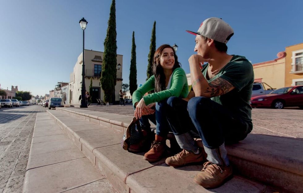 young couple sit outside and have lively conversation