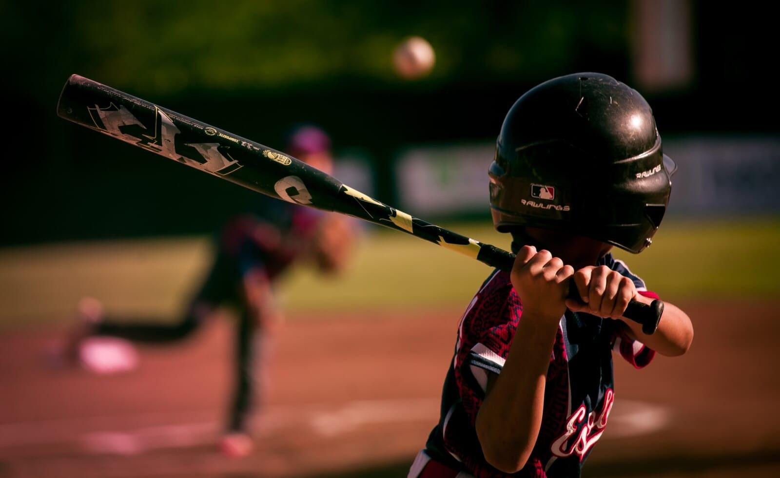 young kid plays baseball up to bat