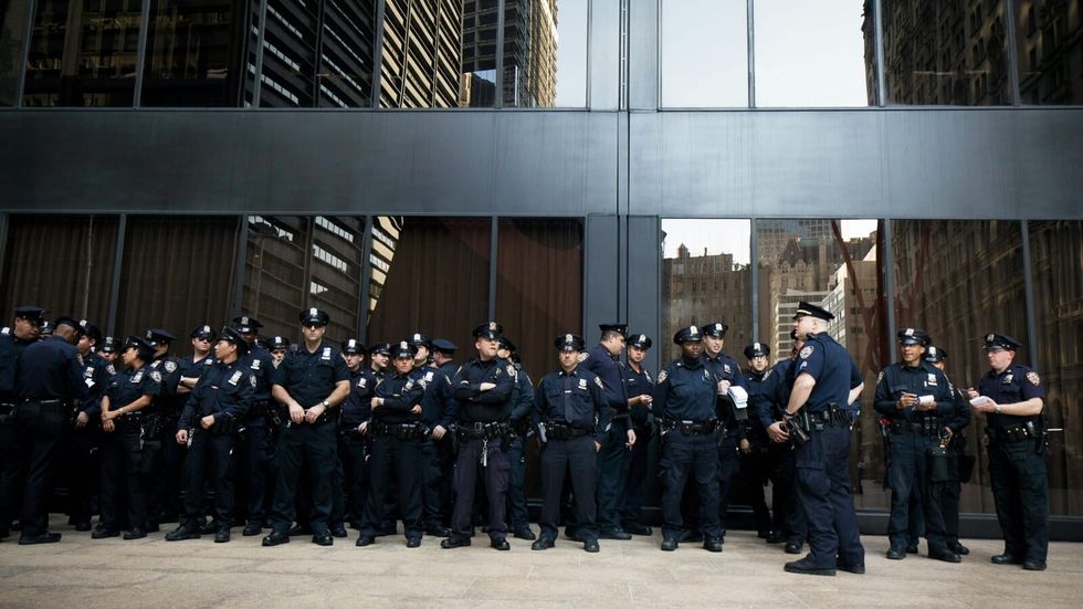 many police officers standing in front of a glass building