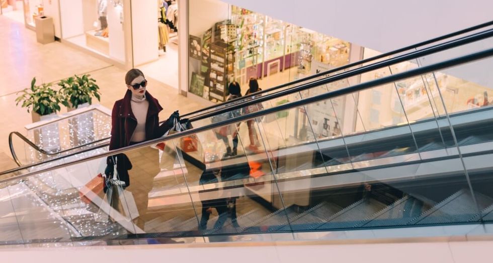 woman wearing sunglasses on an escalator