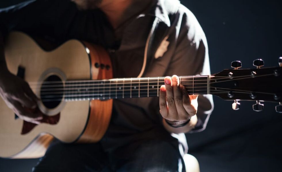 guitar player composes a song on their instrument