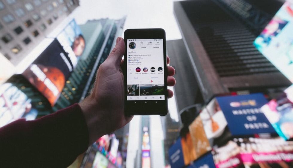 phone being held outdoors in times square new york