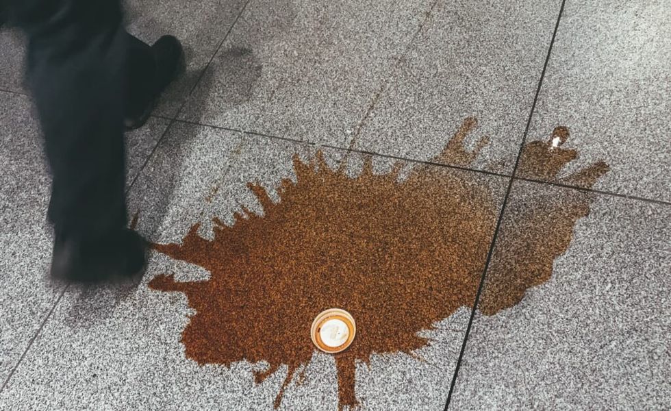 spilled coffee on the concrete outside office building