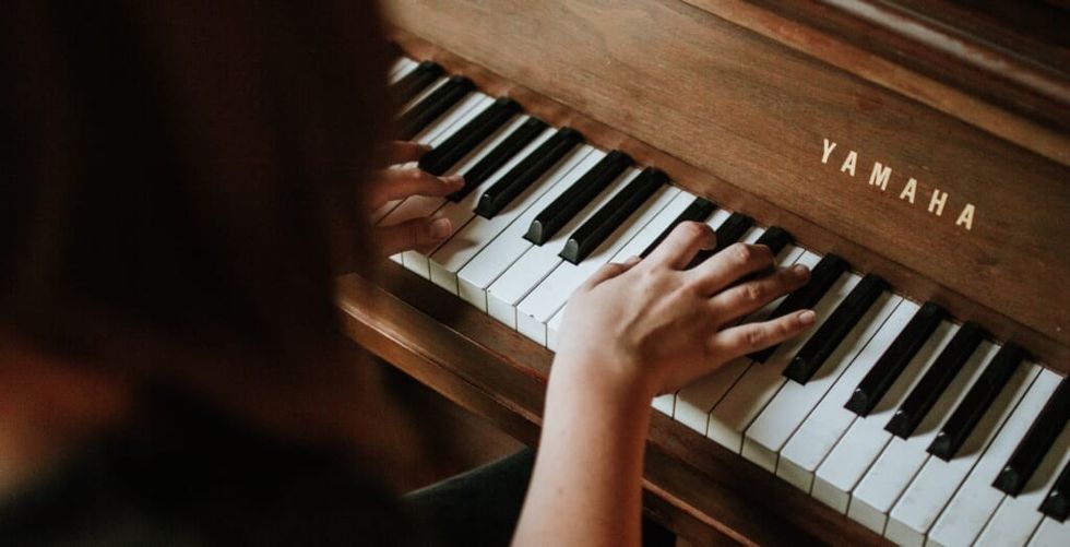 composer works at the piano crafting a song
