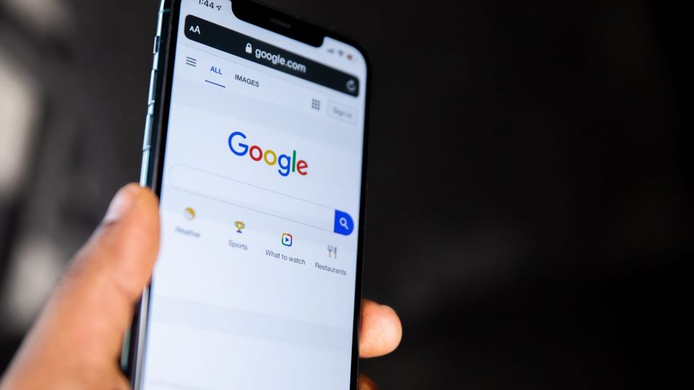person doing a google search on a phone