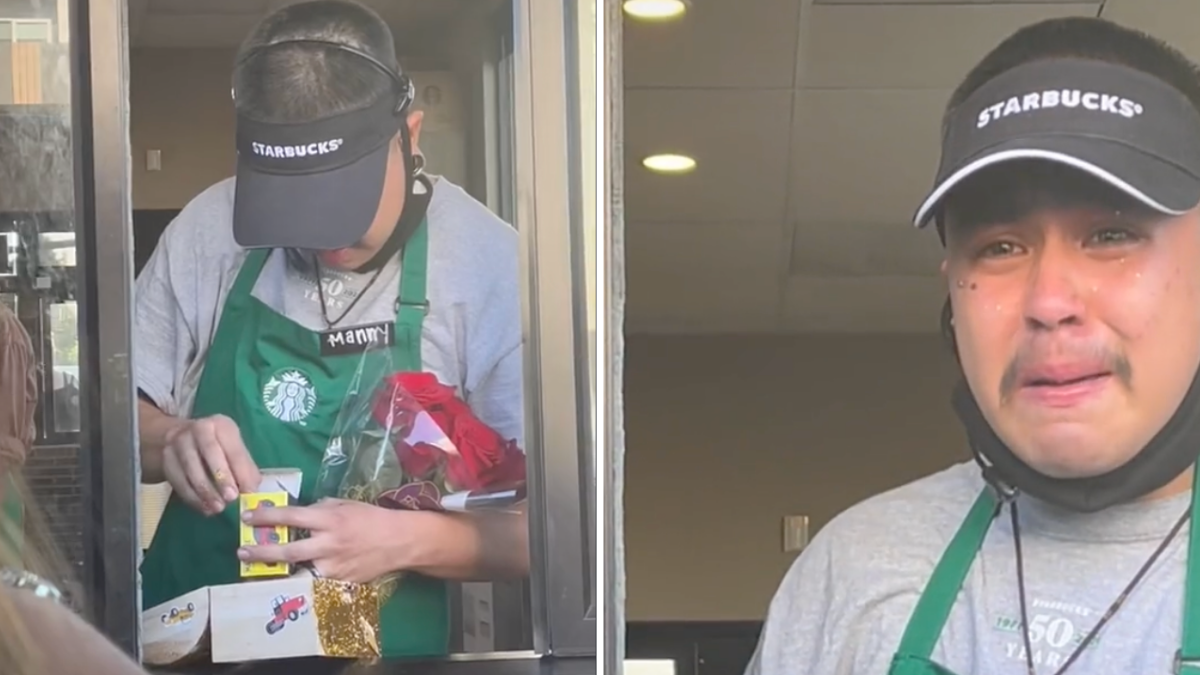 man wearing a green apron opening a present and crying