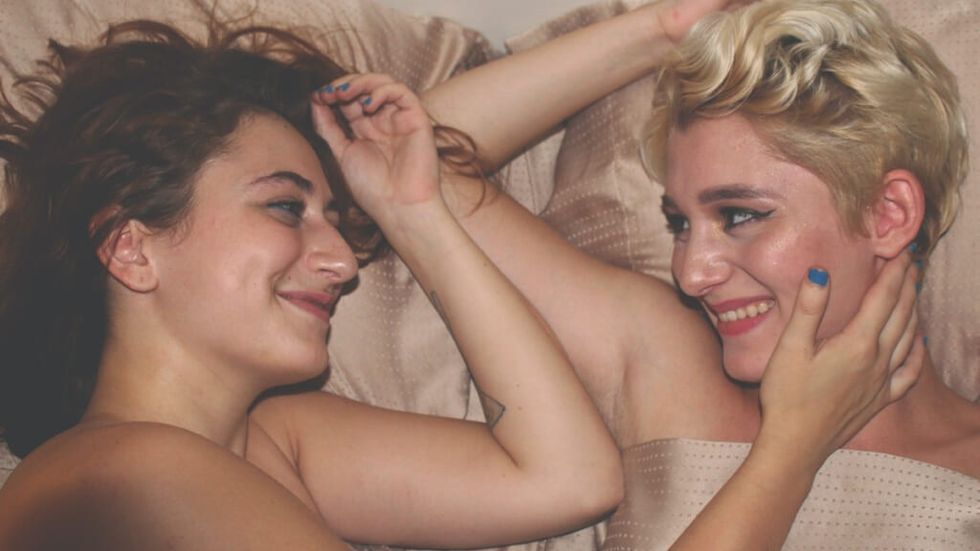 A female couple happy in bed together