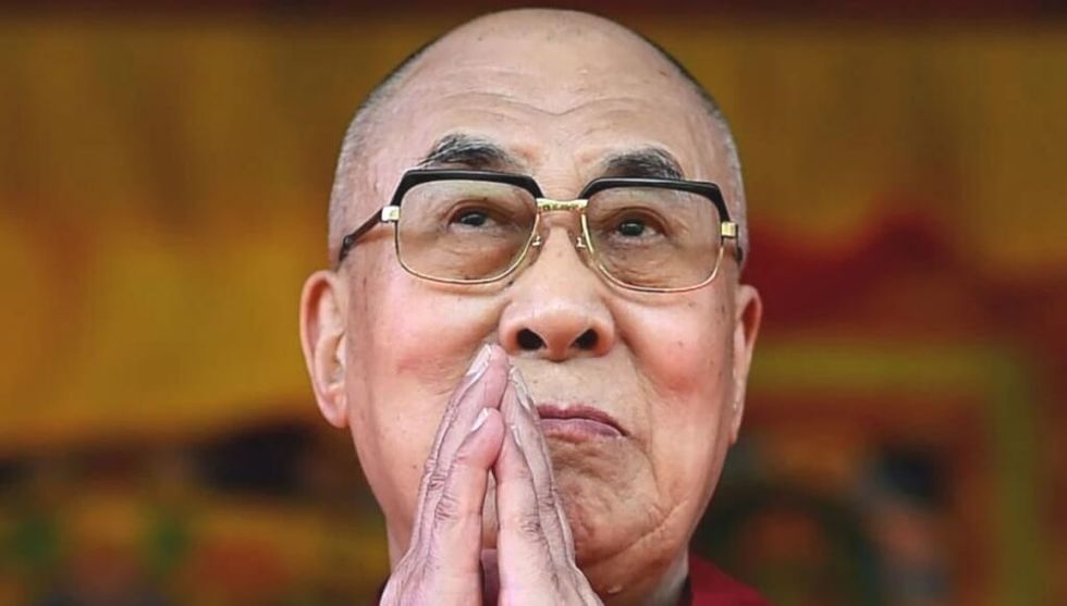 The Dalai Lama praying and looking at the sky