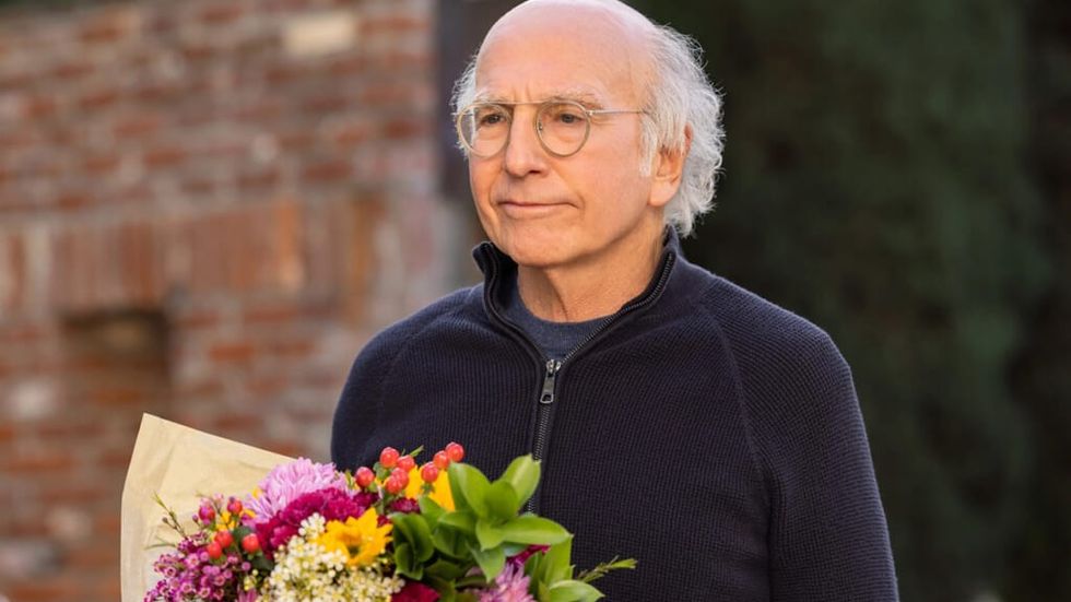 Larry David on Curb Your Enthusiasm holding flowers