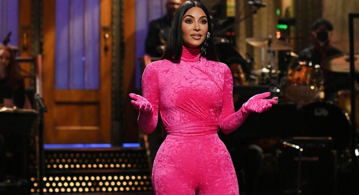 Kim Kardashian during her SNL monologue wearing a hot pink jumpsuit