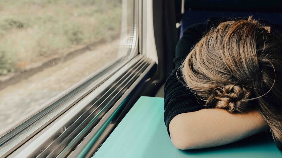 person sleeping on a moving train