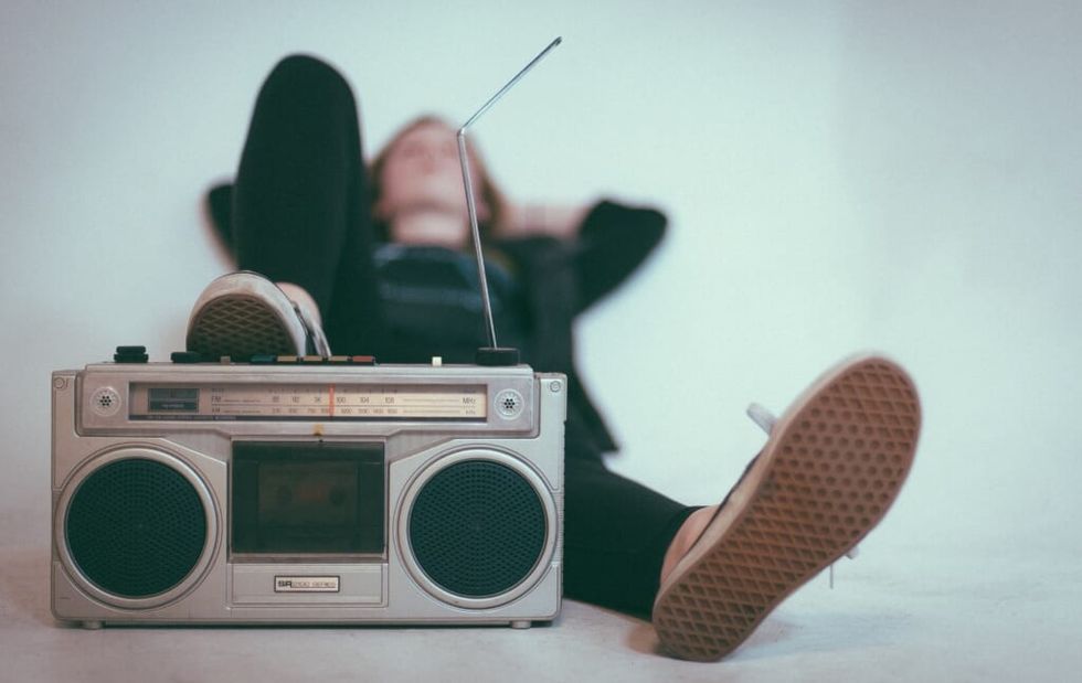 young person relaxes while listening to music