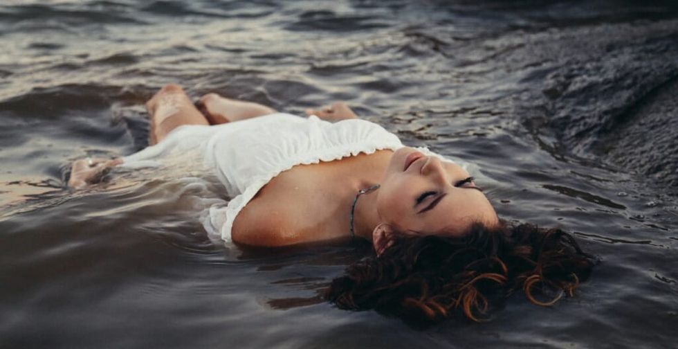 young woman lies in water