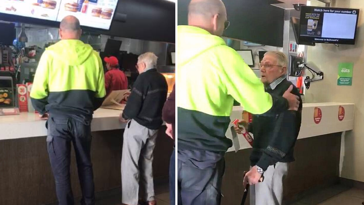 man in green and black jacket stands next to an elderly man in mcdonalds