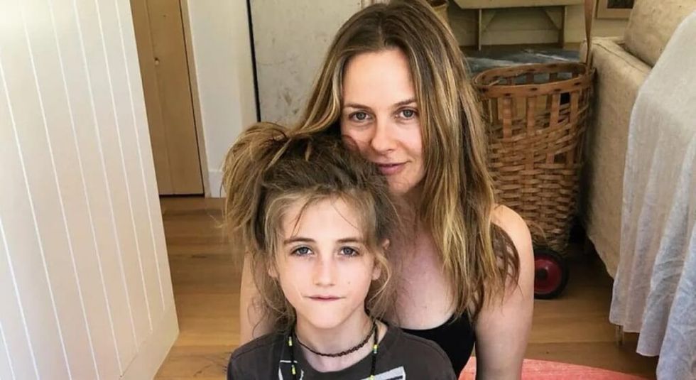 Alicia Silverstone with son Bear sitting in her lap.