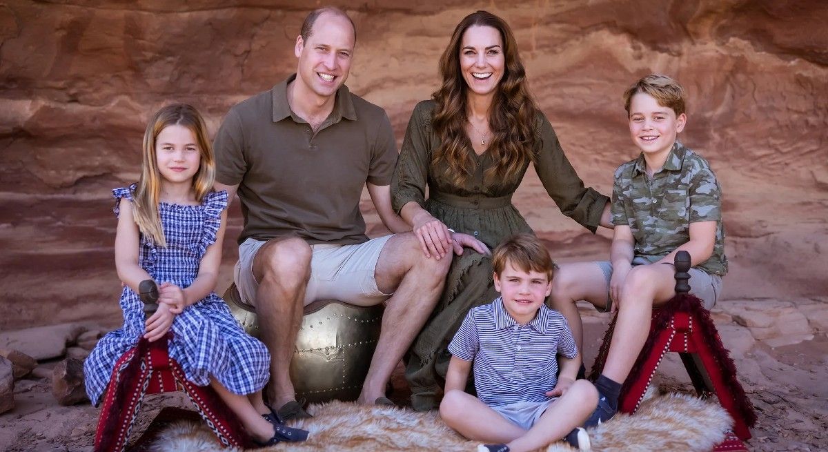 Prince William and Kate family photo with their three children dressed in green or blue.
