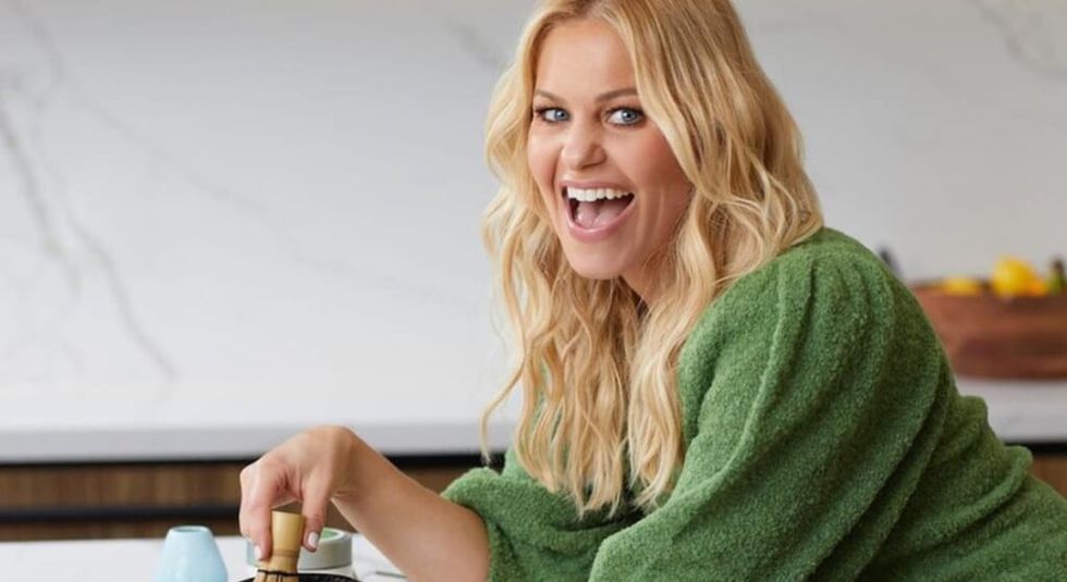 Candace Cameron Bure in green sweater with huge smile