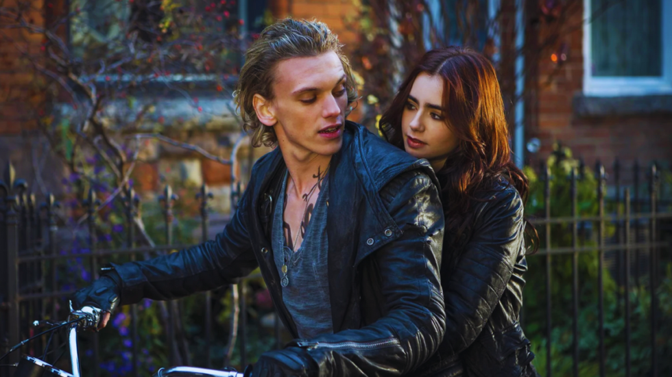 Jamie Campbell Bower on a motorcycle with Lily Collins.