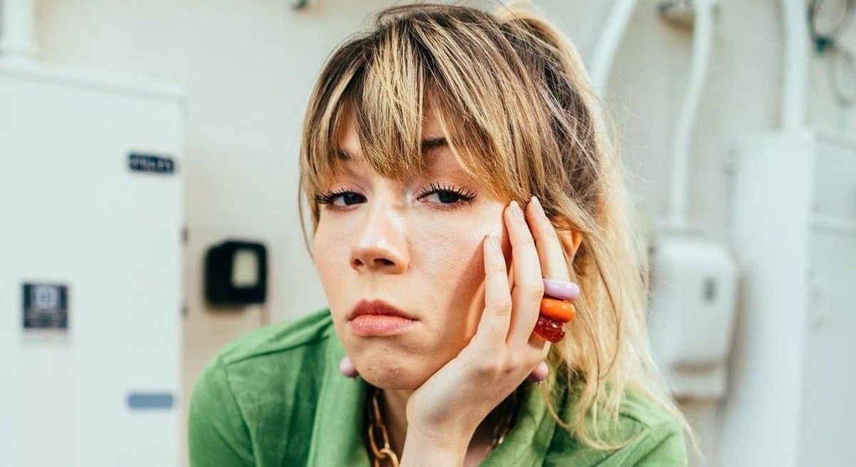 Jennette McCurdy with hand on face looking distraught.