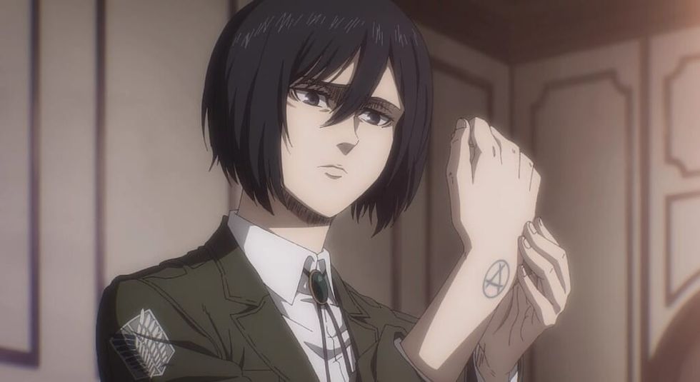 Mikasa Ackermann anime showing off her wrist tattoo