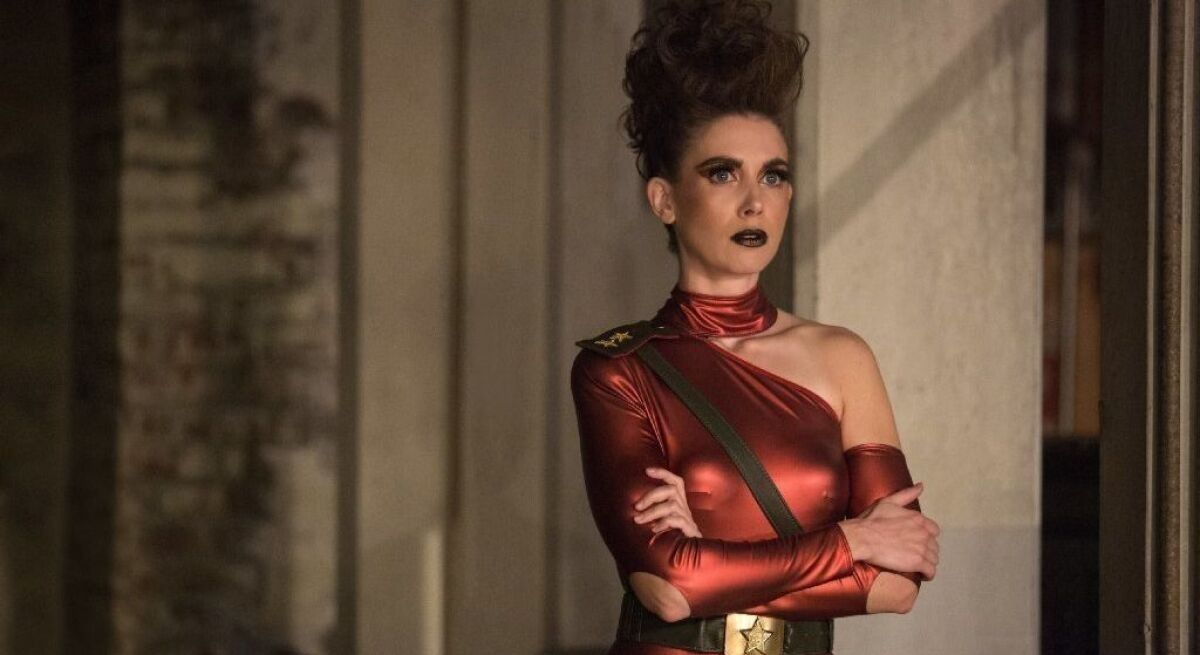 Alison Brie as Zoya the Destroyer in red costume.