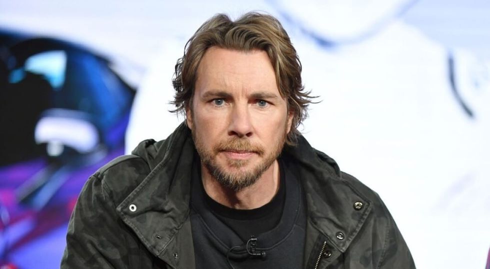 Dax Shepard in leather jacket looking at the camera.