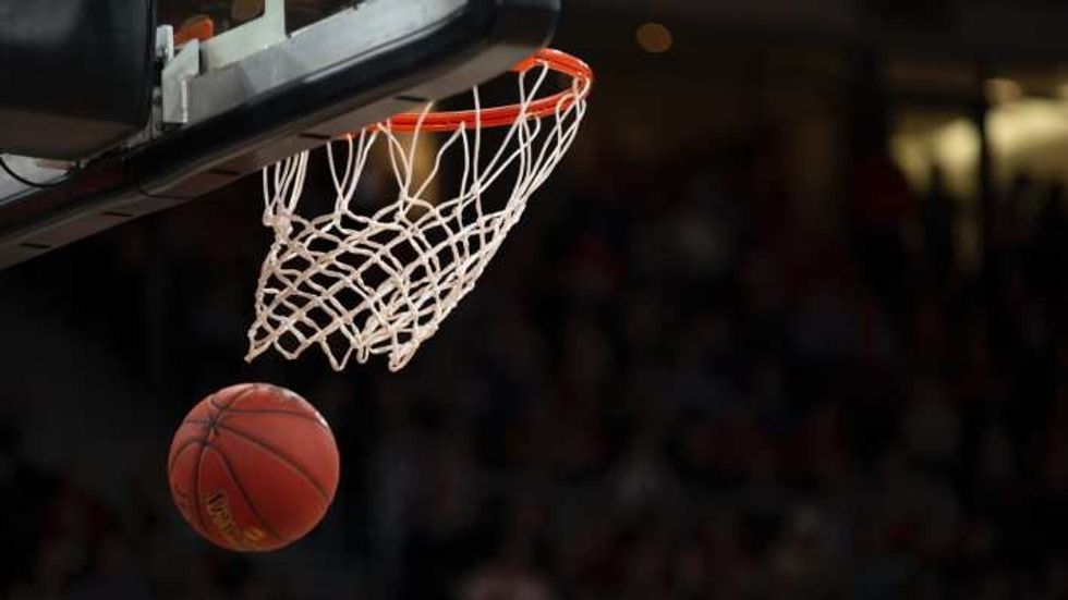 a ball passing through a basketball net 