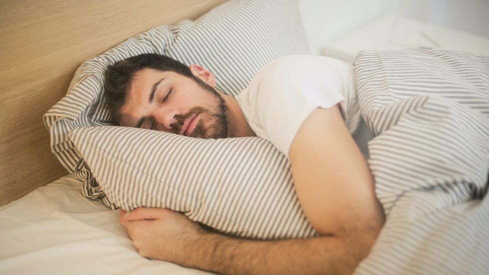 man with beard sleeping in bed