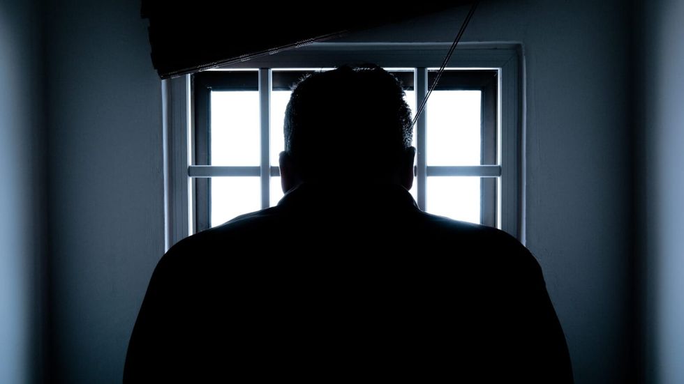 silhouette of man in front of a window
