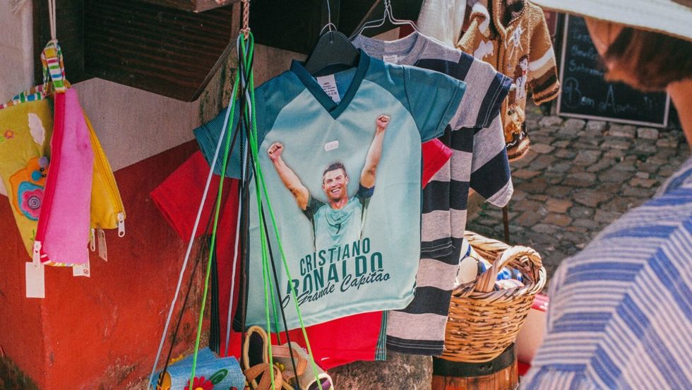 a blue tshirt hanging in a shop