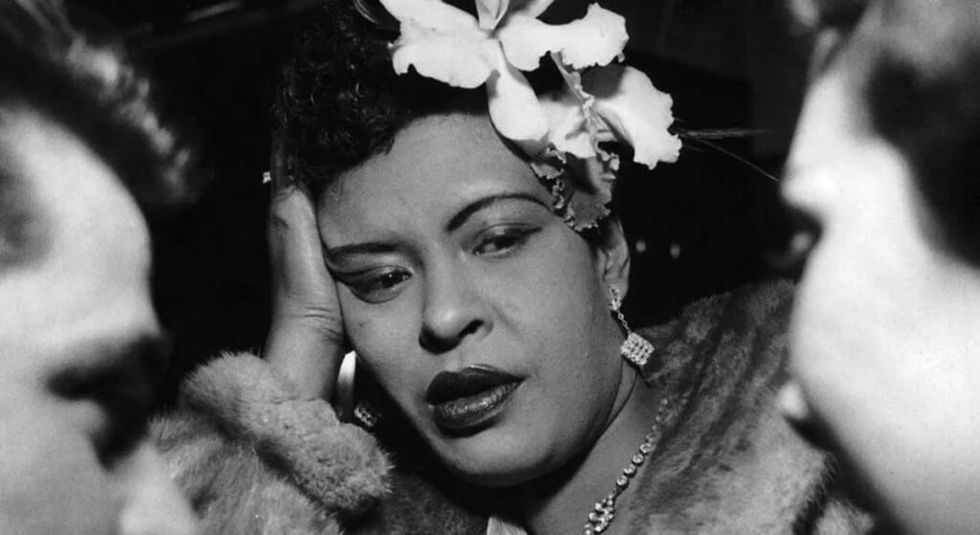 Billie Holiday looking unimpressed during a conversation.