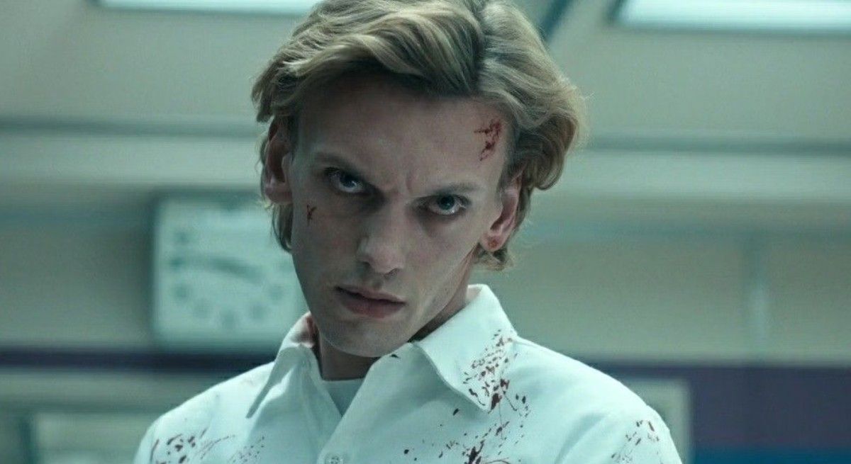 Stranger Things Jamie Campbell Bower in white shirt with blood on covering it.