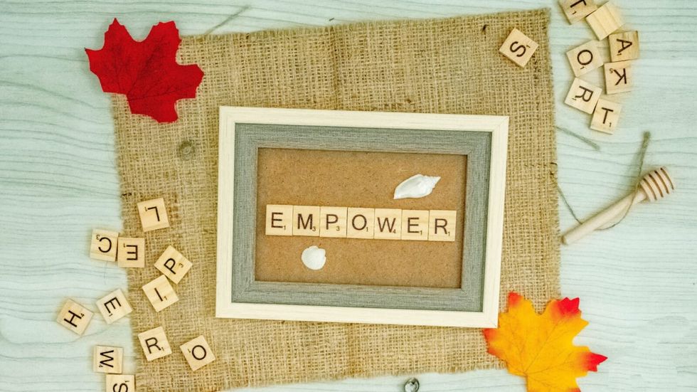"empower" written in letters and a red maple leaf