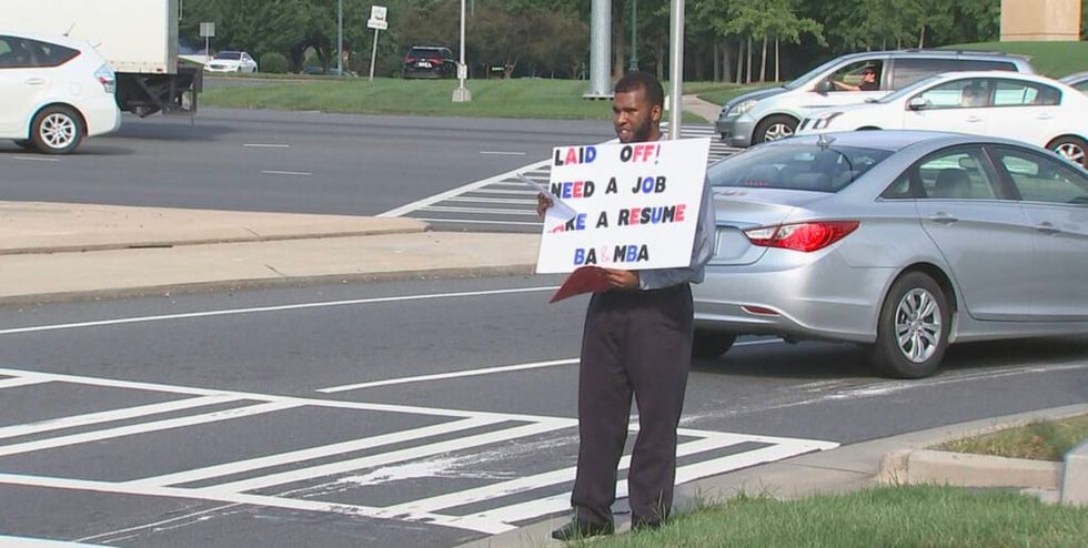 charlotte dad holds sign in traffic