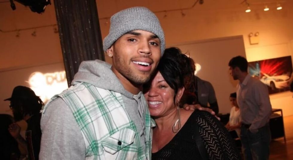 Chris Brown in flannel top and hat hugging mom Joyce Hawkins.
