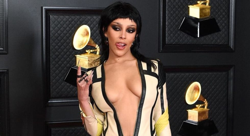 Doja Cat displaying her Grammy in barely there outfit.