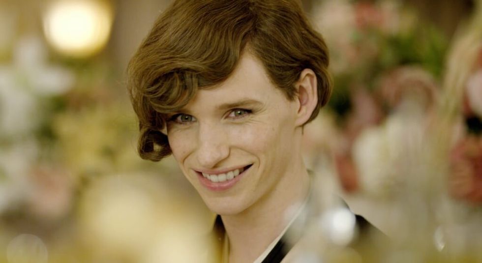 Eddie Redmayne in the Danish Girl in a field with red wig.